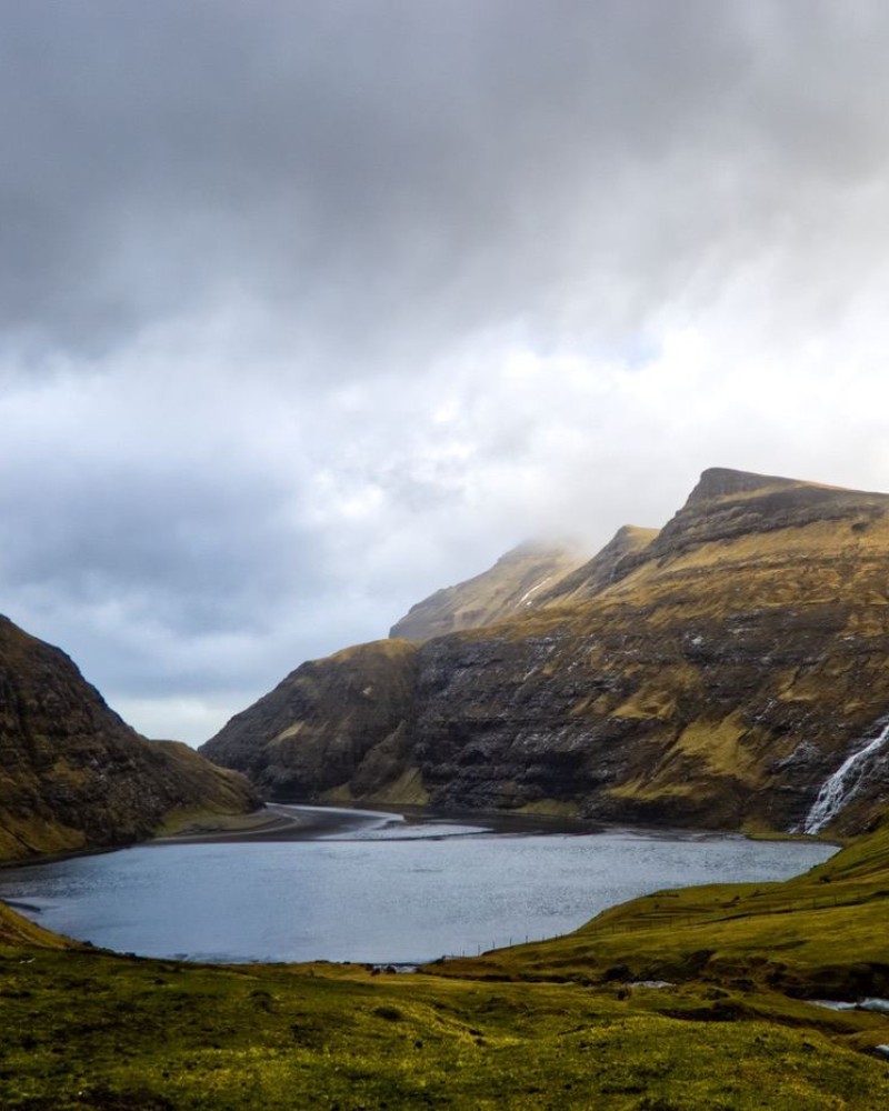 Lake with a waterfall, surrounded by mountains