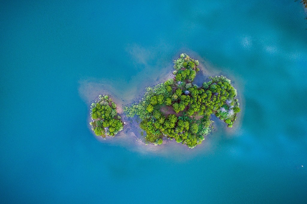 Drone picture of a small, green island